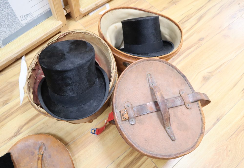 Three silk top hats and leather hat boxes